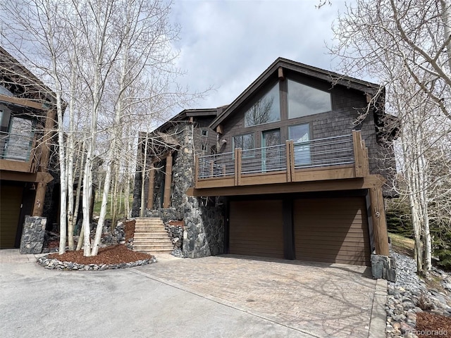 19 S Rd, Breckenridge, CO 80424 - rustic home featuring a balcony, driveway, a garage, and stone siding