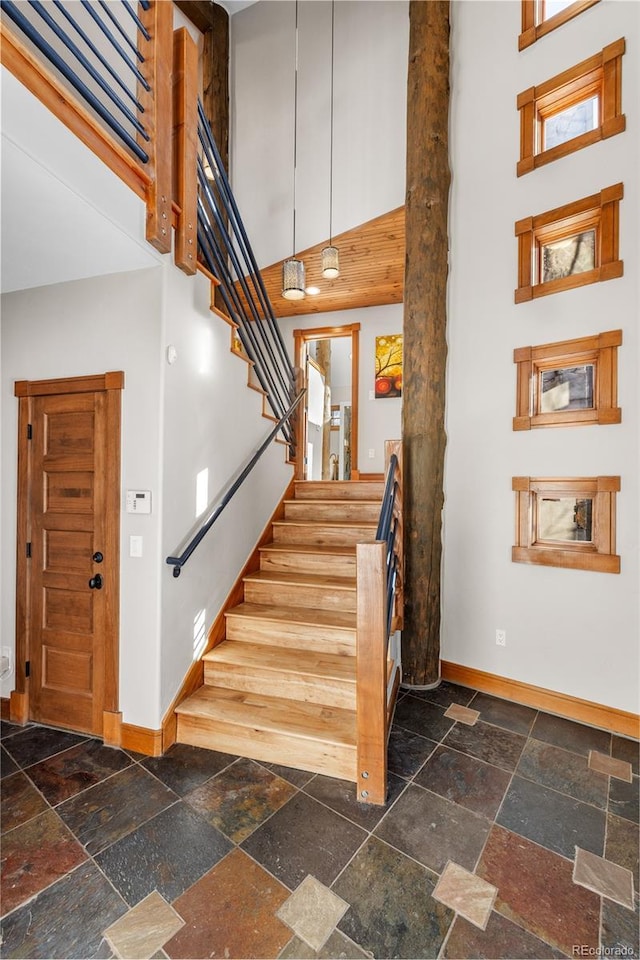 19 S Rd, Breckenridge, CO 80424 - staircase with baseboards, a towering ceiling, and stone tile flooring