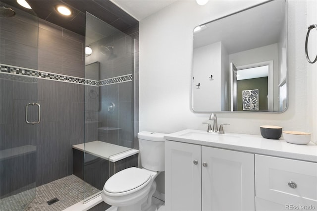 bathroom with toilet, vanity, and walk in shower