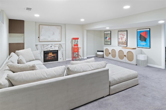 carpeted living room featuring a fireplace