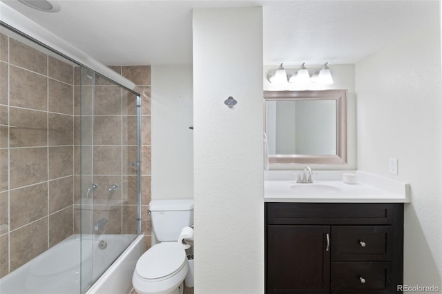 full bathroom featuring toilet, enclosed tub / shower combo, and vanity