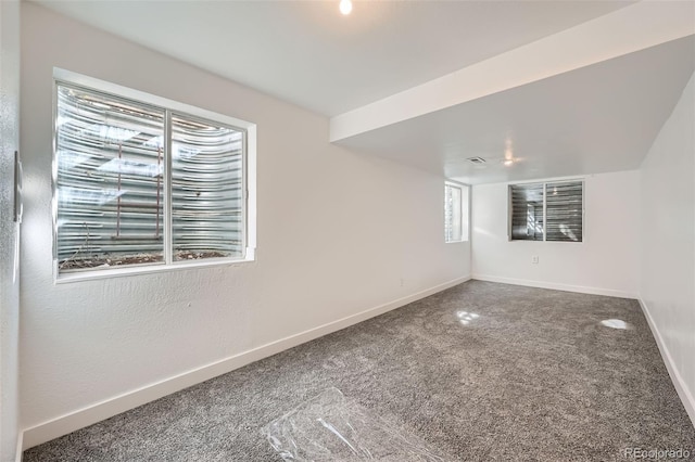 carpeted spare room with baseboards