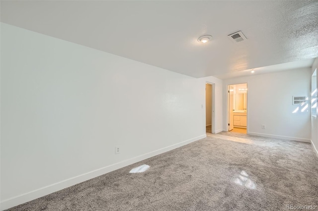 unfurnished room with light colored carpet, visible vents, and baseboards