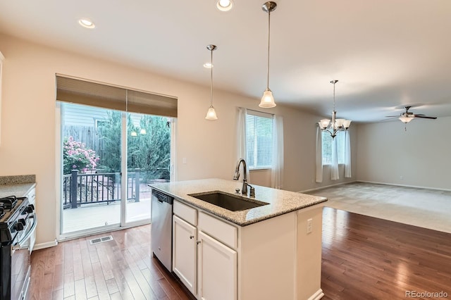13424 W 64th Pl, Arvada, CO 80004 - kitchen featuring a sink, stainless steel dishwasher, black gas range oven, ceiling fan, and white cabinetry