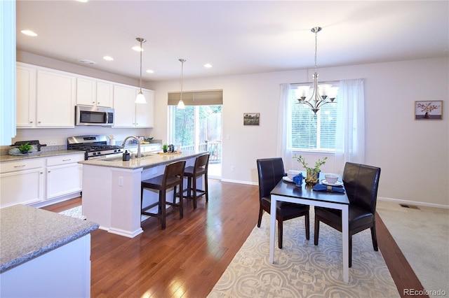 13424 W 64th Pl, Arvada, CO 80004 - dining room with recessed lighting, a chandelier, baseboards, and dark wood-style flooring