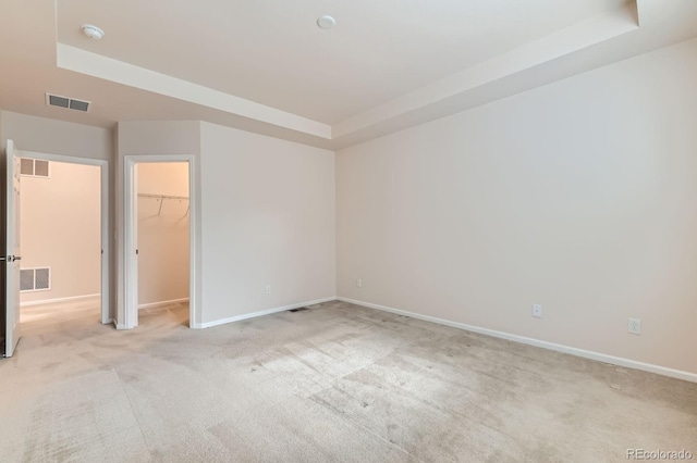 13424 W 64th Pl, Arvada, CO 80004 - unfurnished bedroom with light colored carpet, baseboards, a raised ceiling, and a spacious closet