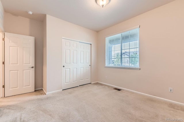13424 W 64th Pl, Arvada, CO 80004 - unfurnished bedroom with light carpet, baseboards, and a closet