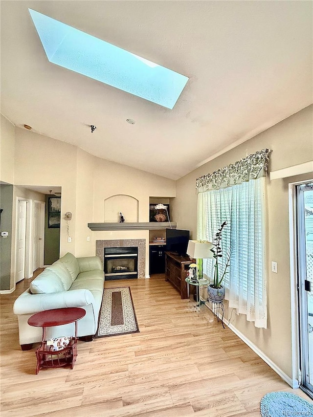 2575 S Syracuse Way Unit F301, Denver, CO 80231 - living area with a skylight, lofted ceiling, wood finished floors, and a fireplace