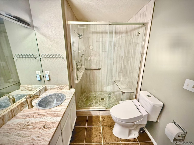 2575 S Syracuse Way Unit F301, Denver, CO 80231 - bathroom featuring vanity, a stall shower, tile patterned flooring, and a textured ceiling