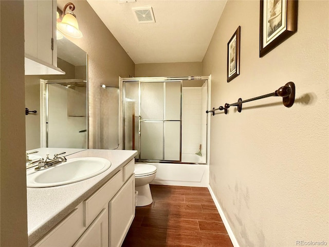 2575 S Syracuse Way Unit F301, Denver, CO 80231 - bathroom featuring vanity, wood finished floors, and combined bath / shower with glass door