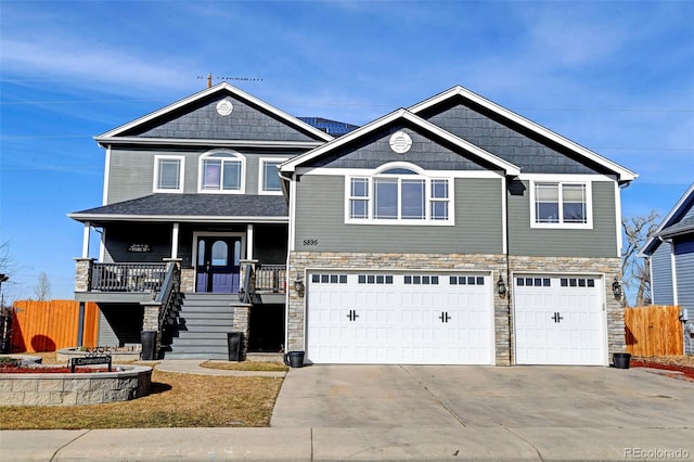 craftsman inspired home with an attached garage, stone siding, covered porch, and driveway
