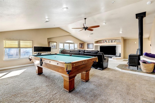 game room with a wood stove, carpet, ceiling fan, vaulted ceiling, and pool table