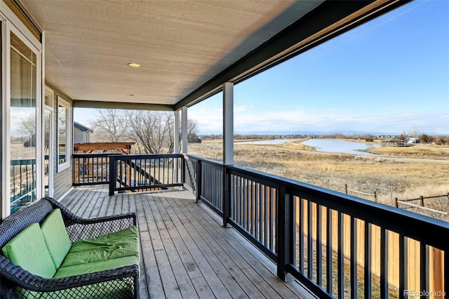 wooden terrace featuring a water view