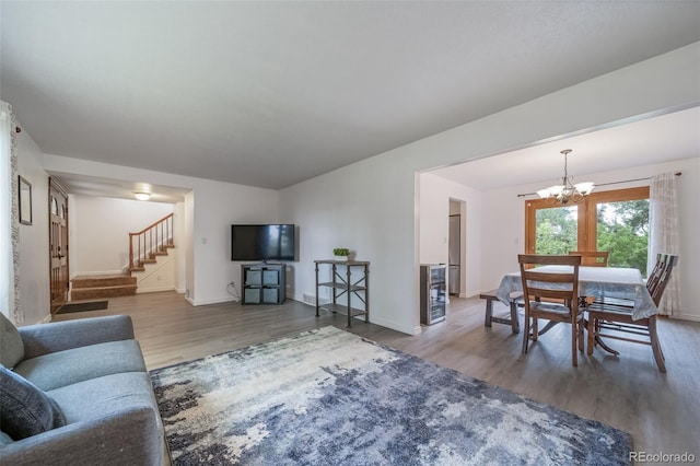 2276 S Dover Way, Lakewood, CO 80227 - living room featuring wood finished floors, a chandelier, baseboards, and stairs