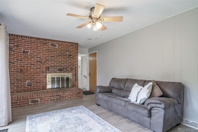 2276 S Dover Way, Lakewood, CO 80227 - living room with wood finished floors, a brick fireplace, and a ceiling fan