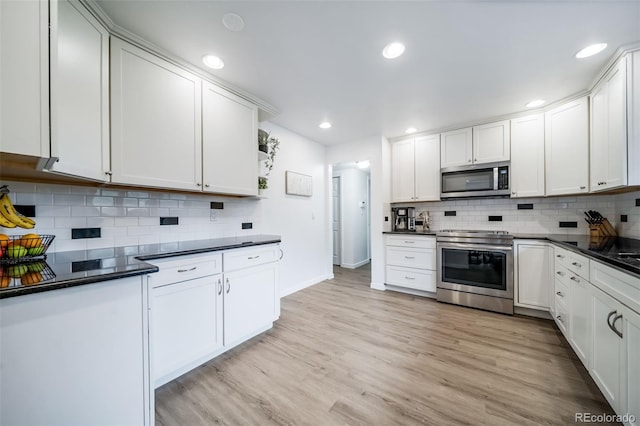2276 S Dover Way, Lakewood, CO 80227 - kitchen featuring stainless steel appliances, dark countertops, tasteful backsplash, light wood-style floors, and recessed lighting