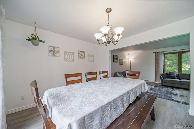 2276 S Dover Way, Lakewood, CO 80227 - dining area featuring dark wood finished floors, a chandelier, and baseboards