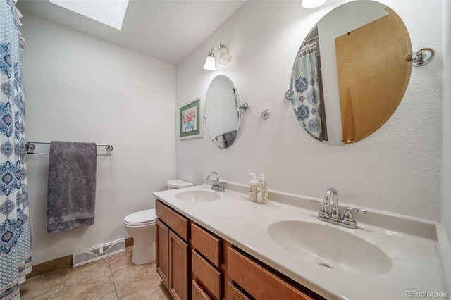 2276 S Dover Way, Lakewood, CO 80227 - full bathroom with a skylight, toilet, and double vanity