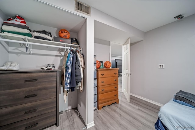 2276 S Dover Way, Lakewood, CO 80227 - bedroom with light wood-type flooring, baseboards, and a closet