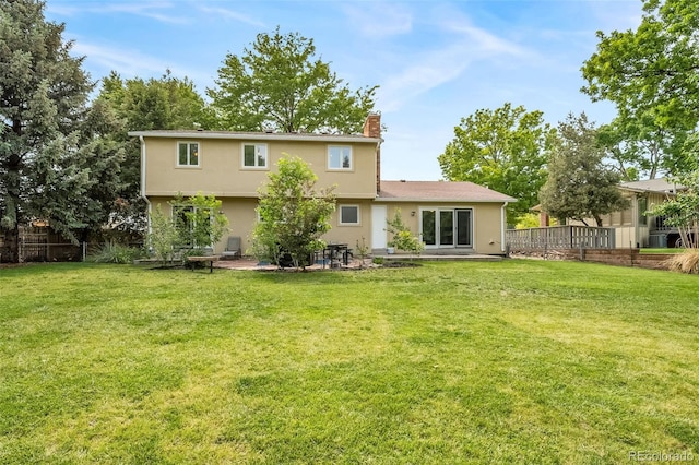 2276 S Dover Way, Lakewood, CO 80227 - rear view of property with a chimney, stucco siding, and a patio area