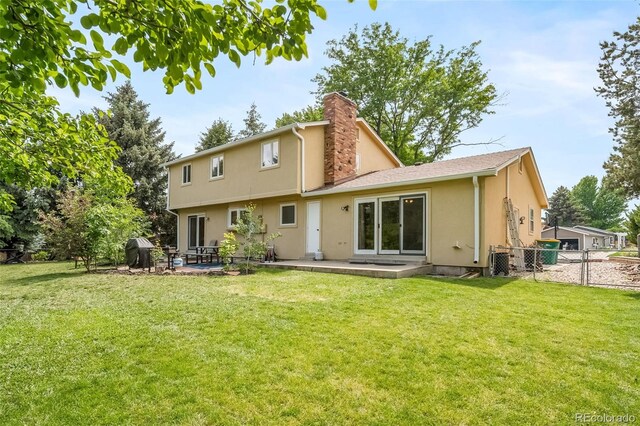 2276 S Dover Way, Lakewood, CO 80227 - back of property with a patio area, stucco siding, and a chimney