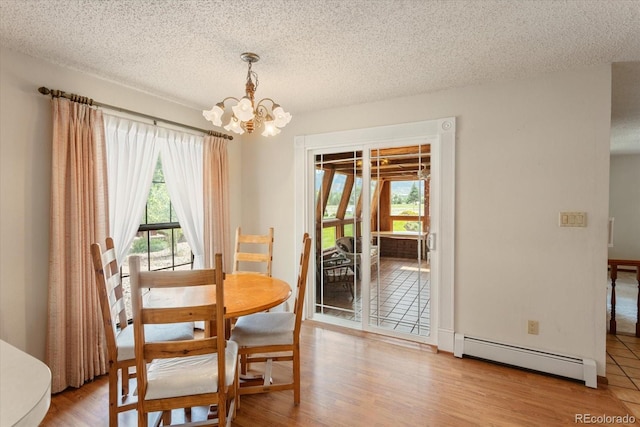 534 Crestone Ave, Salida, CO 81201 - dining room with baseboard heating, a chandelier, a textured ceiling, and wood finished floors