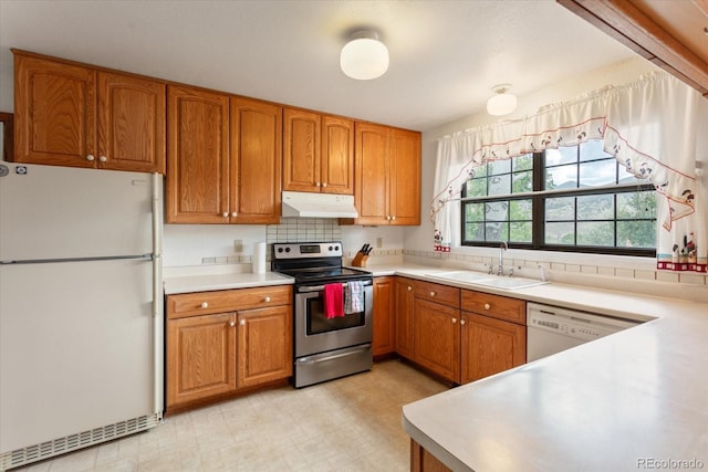 534 Crestone Ave, Salida, CO 81201 - kitchen featuring white appliances, under cabinet range hood, brown cabinetry, and light countertops