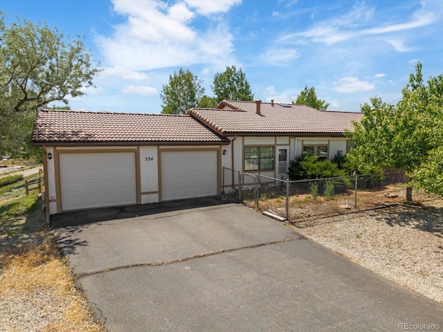 534 Crestone Ave, Salida, CO 81201 - ranch-style home with a tile roof, stucco siding, driveway, and a garage