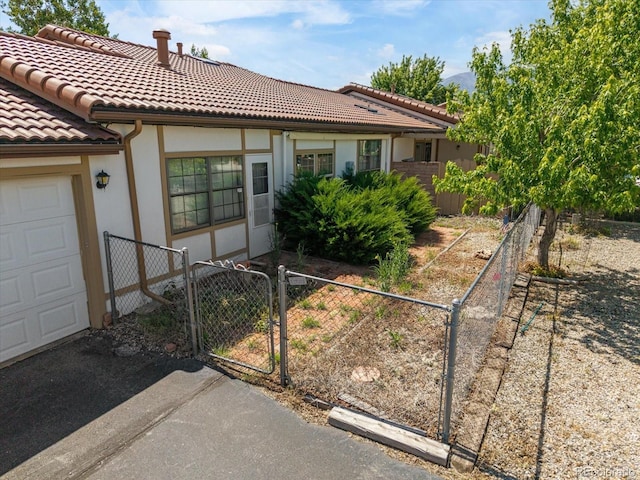 534 Crestone Ave, Salida, CO 81201 - view of front of house featuring a gate, a tiled roof, a garage, and stucco siding