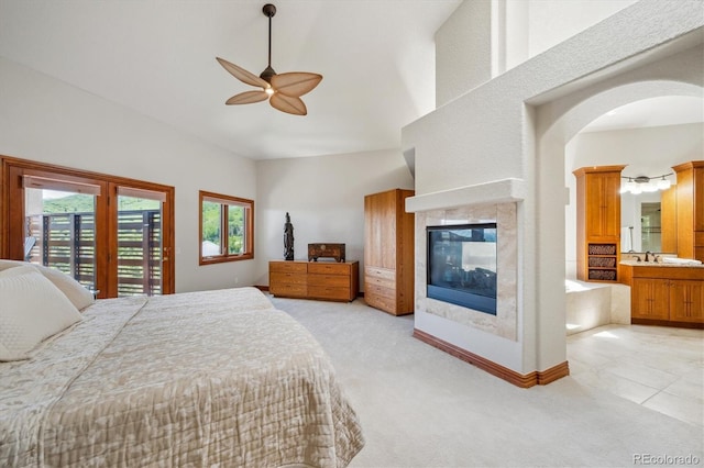 16442 Rocky Point Ln, Morrison, CO 80465 - bedroom with light carpet, access to outside, multiple windows, and a tiled fireplace