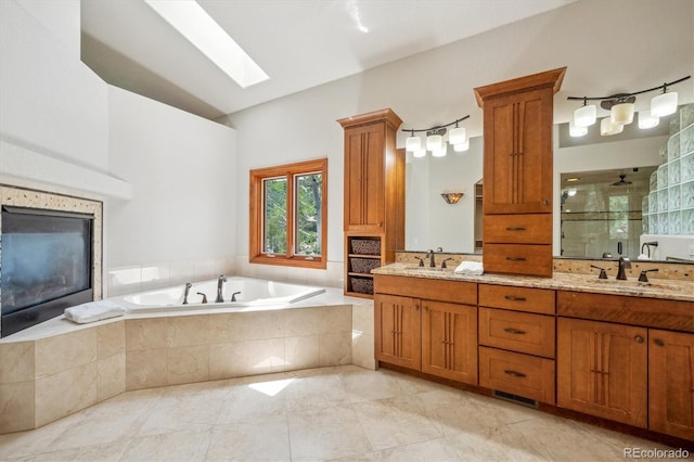 16442 Rocky Point Ln, Morrison, CO 80465 - bathroom featuring double vanity, a shower stall, a garden tub, and a skylight