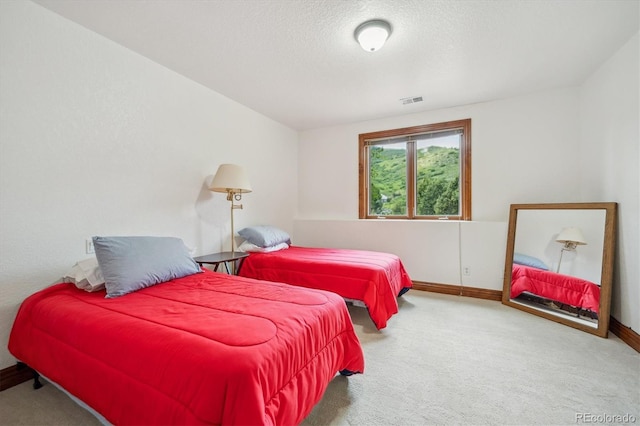 16442 Rocky Point Ln, Morrison, CO 80465 - carpeted bedroom with baseboards and a textured ceiling