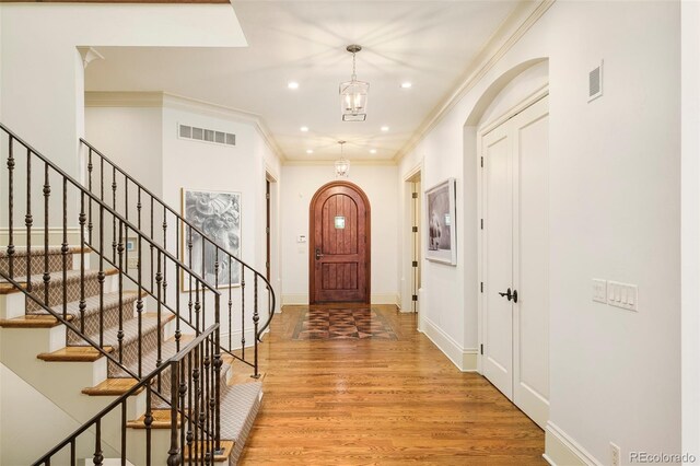 958 S Columbine St, Denver, CO 80209 - foyer entrance featuring wood finished floors, stairs, recessed lighting, crown molding, and baseboards