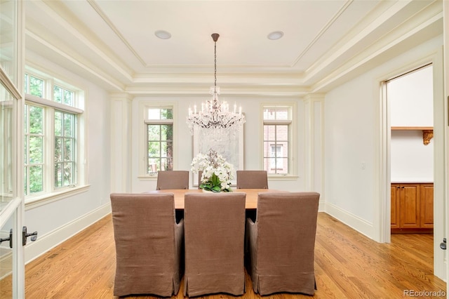 958 S Columbine St, Denver, CO 80209 - dining space featuring a raised ceiling, light wood-style flooring, a chandelier, and crown molding
