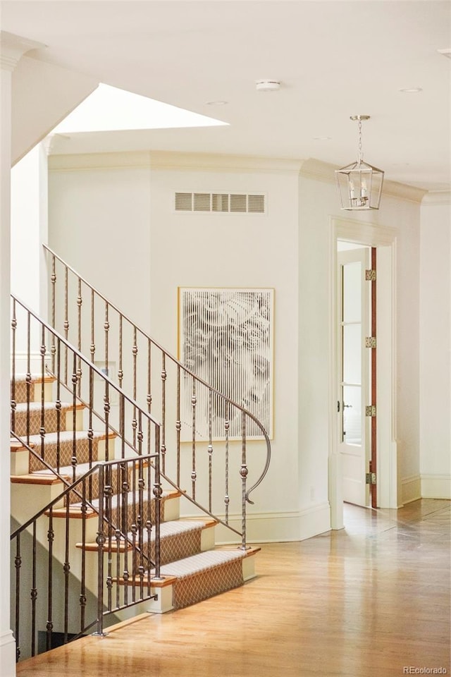 958 S Columbine St, Denver, CO 80209 - stairs with wood finished floors, baseboards, and crown molding