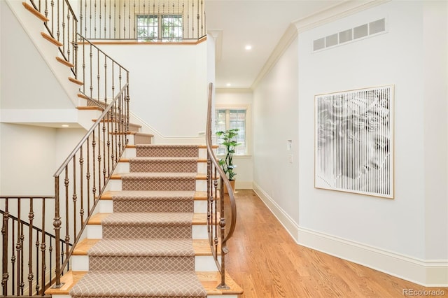 958 S Columbine St, Denver, CO 80209 - stairs with wood finished floors, crown molding, baseboards, and recessed lighting