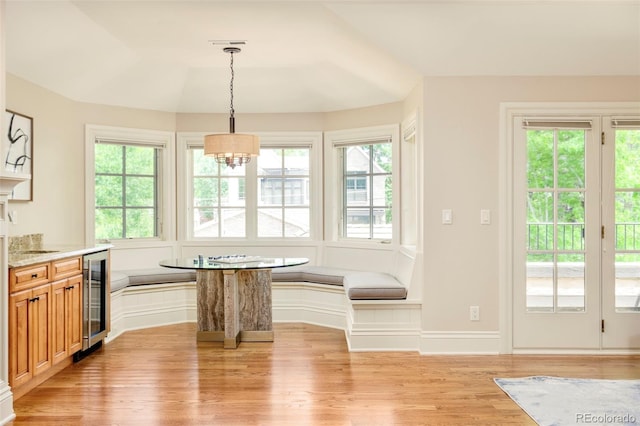 958 S Columbine St, Denver, CO 80209 - dining area featuring breakfast area, beverage cooler, light wood-type flooring, and healthy amount of natural light