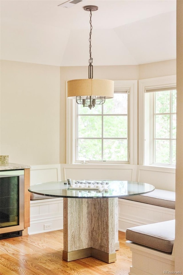 958 S Columbine St, Denver, CO 80209 - kitchen with beverage cooler, light wood-style flooring, a chandelier, and decorative light fixtures