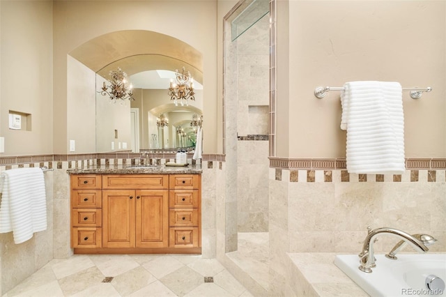 958 S Columbine St, Denver, CO 80209 - full bathroom featuring tile walls, a garden tub, a chandelier, vanity, and a walk in shower