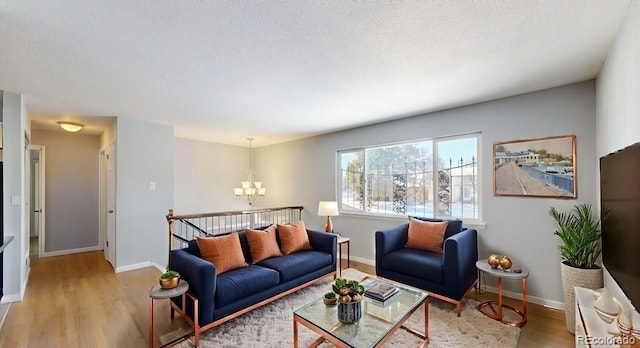 living room with hardwood / wood-style floors and a chandelier