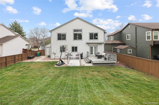 back of house with a yard, french doors, a fenced backyard, and a deck