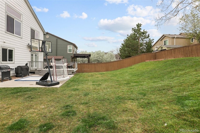 view of yard featuring a patio area, fence, and a deck