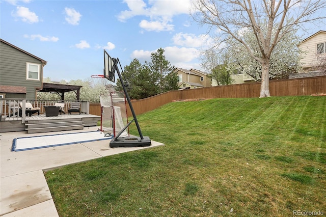view of yard with a deck and fence