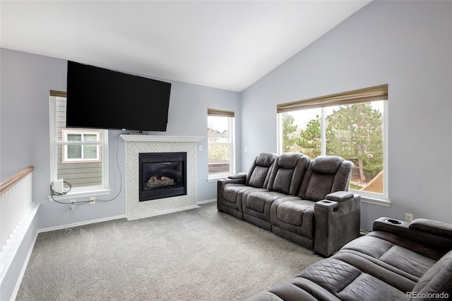 living room featuring a tile fireplace, high vaulted ceiling, baseboards, and carpet