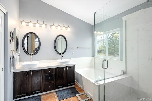 bathroom with a sink, a marble finish shower, double vanity, and a garden tub