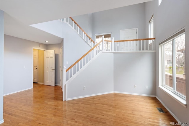 interior space with wood finished floors, baseboards, and visible vents