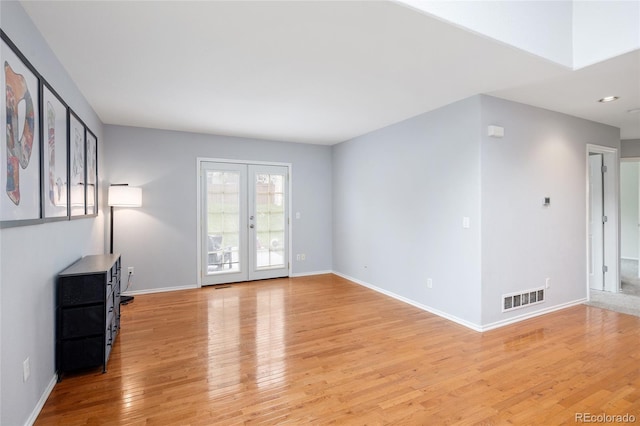unfurnished living room with visible vents, baseboards, and light wood-type flooring