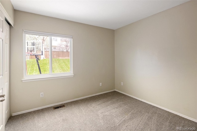 carpeted empty room with visible vents and baseboards