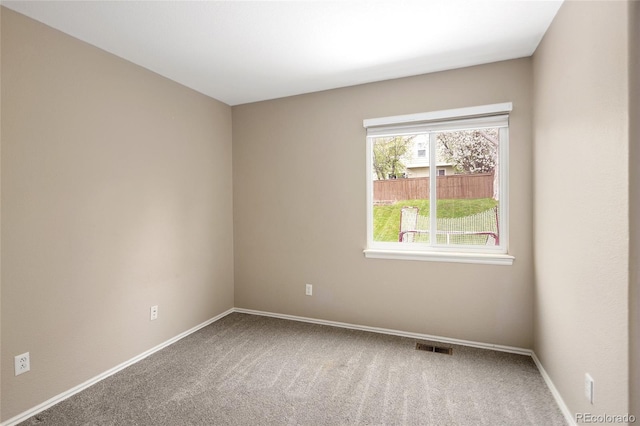 carpeted empty room with baseboards and visible vents