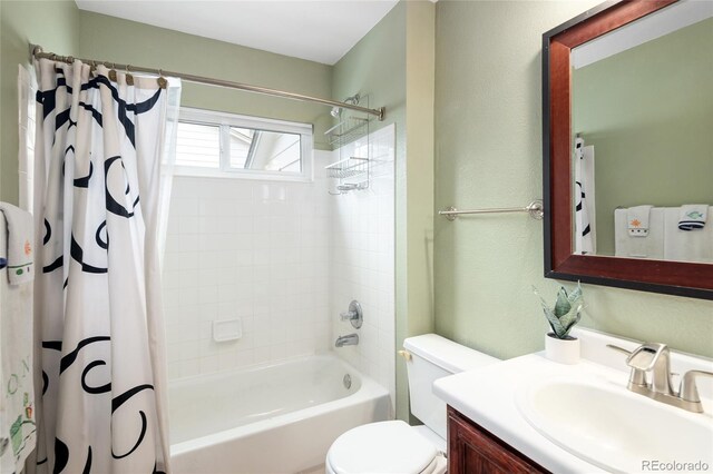 bathroom featuring toilet, vanity, and shower / tub combo with curtain